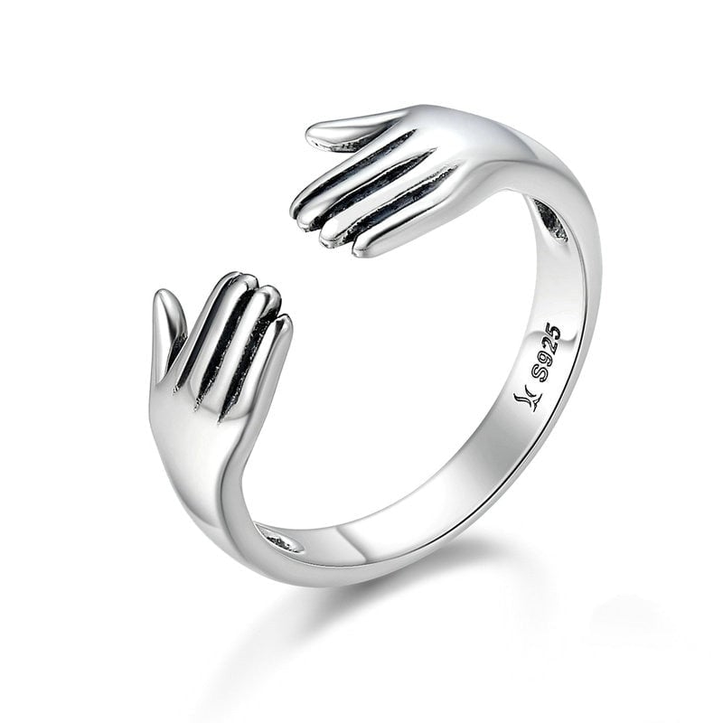 Bague Câlin <titolo_esteso><span>en argent 925 plaqué or blanc ajustable avec étreinte et détail des mains</span></titolo_esteso>