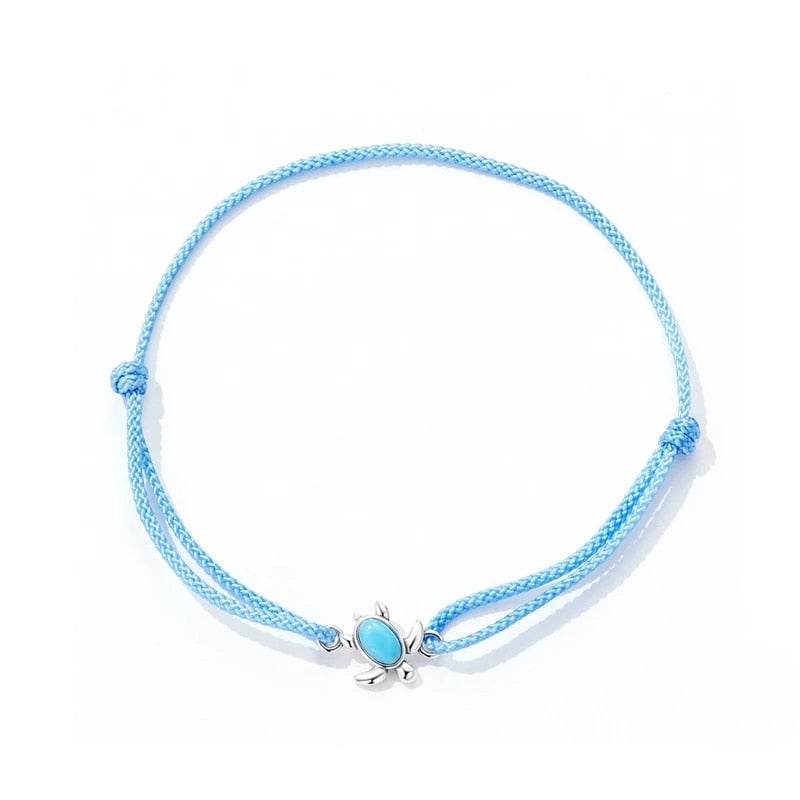 Bracelet Tortue <titolo_esteso><span>style marin en corde bleue ajustable avec tortue en argent 925 et pierre turquoise</span></titolo_esteso>