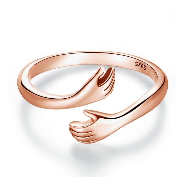 Bague Câlin d'Amour <titolo_esteso><span>en argent 925 plaqué or rose ajustable avec étreinte et détail des mains</span></titolo_esteso>