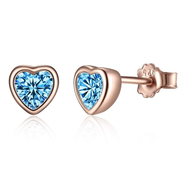 Boucles d'Oreilles Coeurs <titolo_esteso><span>en argent 925 plaqué or rose avec zircons bleus</span></titolo_esteso>